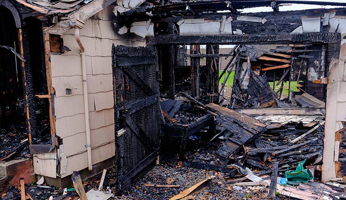 Charred residential structure after fire damage Charred residential structure after fire damage
