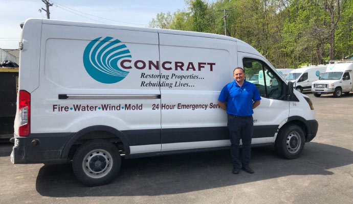 Concraft team servicing a vehicle with a team member