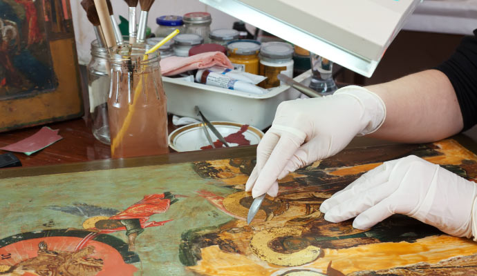 Professional restoring an art piece