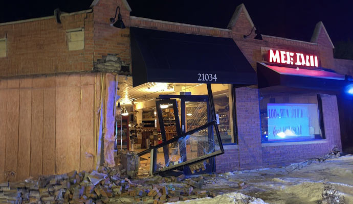 a storefront with significant damage to the entrance