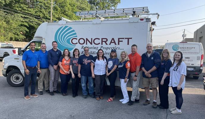 Concraft team posed with service vehicle Concraft team standing in front of their service vehicle