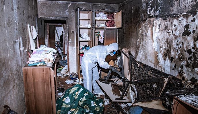 Fire damage cleaning and restoration services An expert restoring and cleaning fire-damaged interior