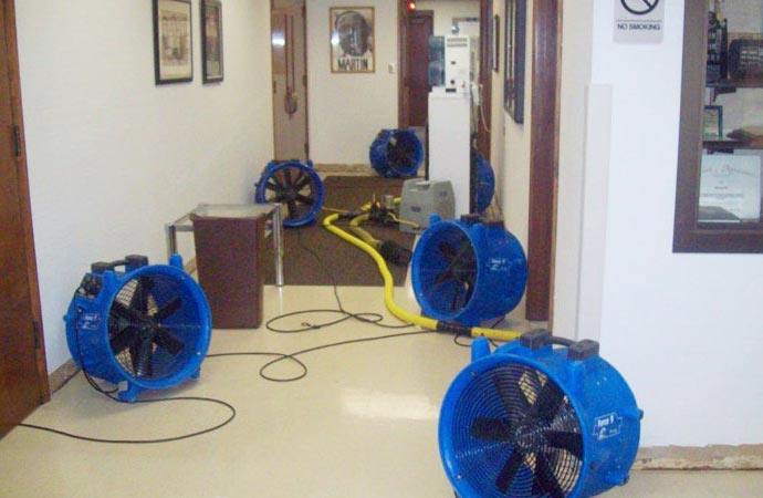 water damage restoration equipment setup on the floor