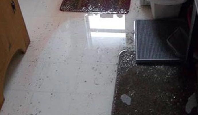 Wet tiled floor inside a home due to plumbing overflow Wet tiled floor inside a home due to plumbing overflow